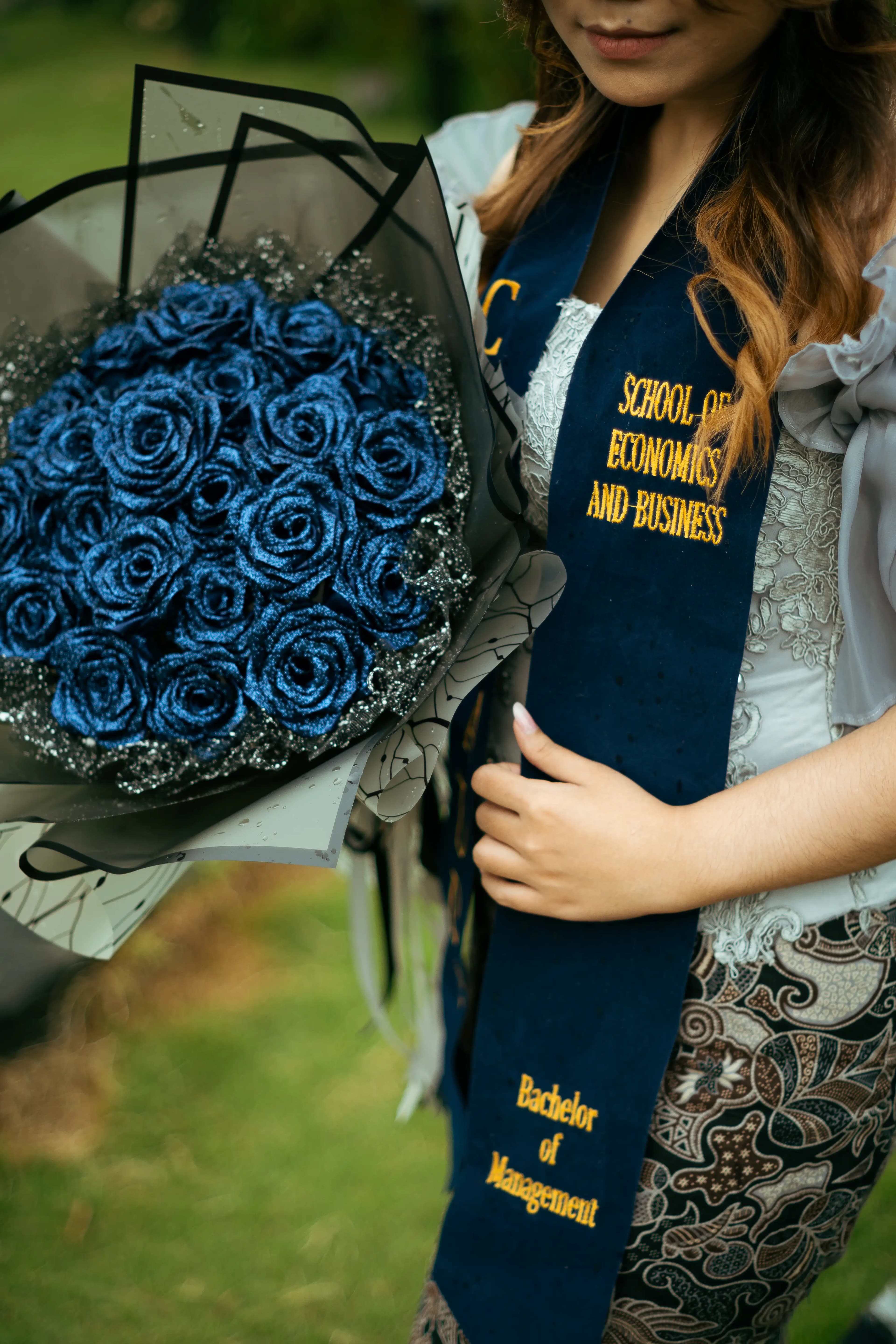 Graduation detail — bouquet and sash at Widya Kartika Surabaya 2024 — foto wisuda Surabaya